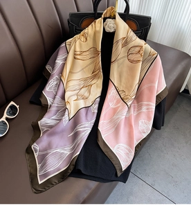 Detailed view of luxury silk scarf with tulip flower print and elegant Morandi color blocks