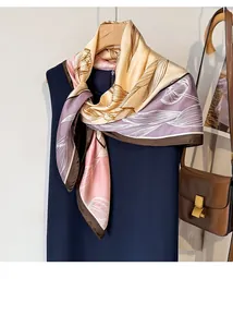 Detailed texture of silk scarf with floral patterns draped on a hanger with blue dress