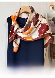 Detail of floral silk scarf with large print on navy dress for summer styling