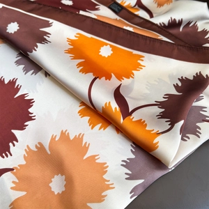 Floral print silk feeling scarf in cream white with orange and brown flower patterns