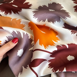 Close-up of elegant floral print silk scarf with satin texture and soft draping