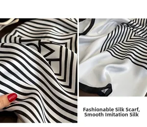 Detail of silk-like scarf showing smooth texture and modern black-white geometric pattern