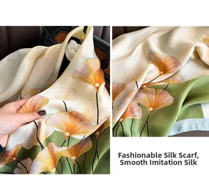 Dettaglio della sciarpa in finta seta con stampa ginkgo che mostra trama e drappeggio