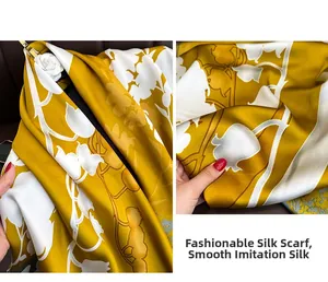 Detail showing the silky texture and elegant white floral pattern on the yellow faux silk scarf