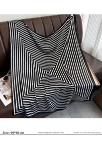 Detailed view of 90x90cm striped silk satin scarf on leather background with accessories