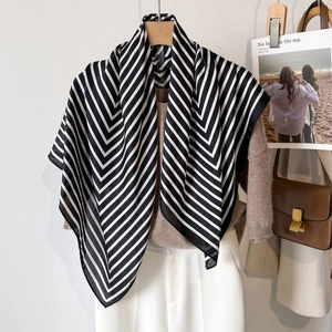 Classic black and white striped satin scarf styled with an elegant casual outfit