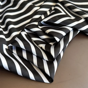 Detailed view of striped satin scarf with smooth silk texture and diagonal pattern