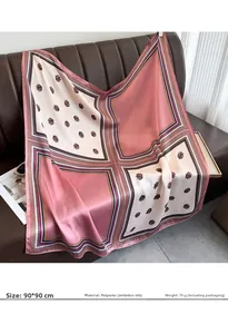 Detail of 90x90cm faux silk floral scarf with pink and beige pattern on a sofa