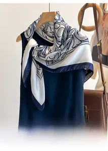 Detail of blue and white printed satin scarf styled on a sleeveless professional top