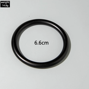 Detail shot of black acrylic geometric bangle showing 14.8g weight and 6.6cm diameter