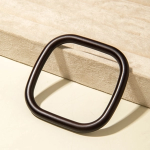 Detailed close-up of dark acrylic geometric resin frame accessory on display stand