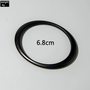 Detail of minimalist matte black acrylic geometric bracelet showing 6.8cm diameter size