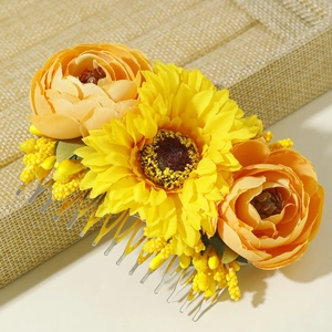 Bohemian floral hair comb with yellow sunflower and orange ranunculus on woven stand