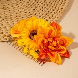 Detail of bohemian sunflower hair comb with yellow fabric petals and golden metal teeth