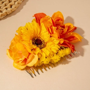 Close-up of bohemian floral hair comb with yellow sunflowers and orange faux petals