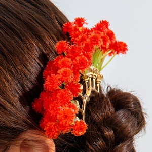 Detail view of red floral cluster hair comb accessory for elegant side hairstyles