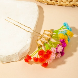 Macro view of Bohemian metal hair comb featuring vibrant multi-colored faux flowers
