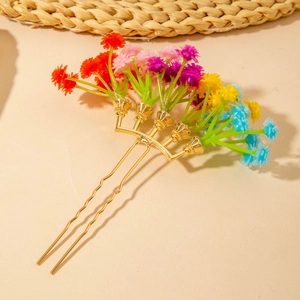 Detail of colorful artificial flower hair comb with gold-tone dual-tooth metal prongs