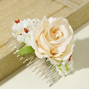 Detailed view of champagne rose hair comb with silk flowers and silver metal teeth