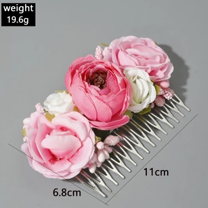 Detail of pink and white silk roses on a floral hair comb with metal teeth