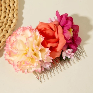 Detailed close-up of Bohemian hair comb with colorful artificial flowers and berries