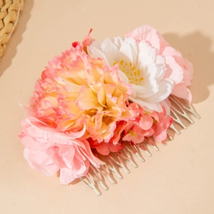 Detail of pink and white fabric flower hair comb with silver metal prongs