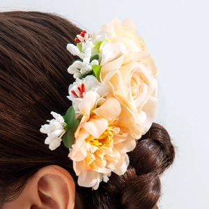 Detail of silk champagne rose hair comb with green leaves and white accent flowers