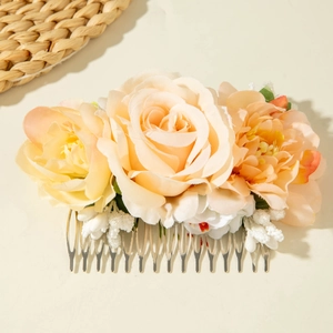 Detail of bohemian floral hair comb with champagne artificial flowers and silver metal teeth