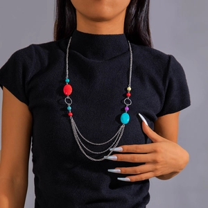 Detail van kleurrijke boho meerlaagse kralenketting op zwarte coltrui voor dames