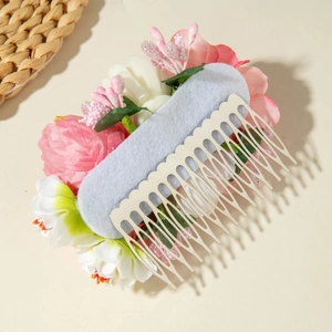 Detailed view of handmade silk flower hair comb with pink petals and silver metal teeth