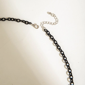 Close-up of black acrylic chain link necklace with adjustable silver lobster clasp