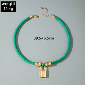 Detailed view of 12.4g gold heart lock pendant on dark green woven cord necklace