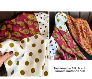 Detailed view of paisley and polka dot print on silky polyester fabric scarf