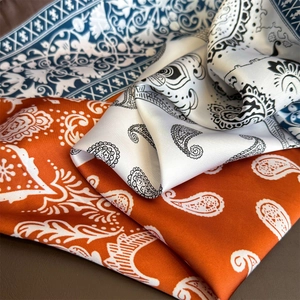 Vintage paisley silk scarves in orange, white and blue with elegant glossy texture