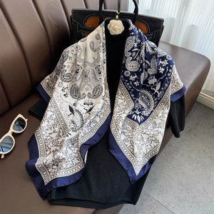 Vintage navy and cream paisley silk square scarf displayed with fashion accessories