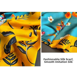 Detail of yellow and teal floral satin scarf showing smooth texture and botanical print