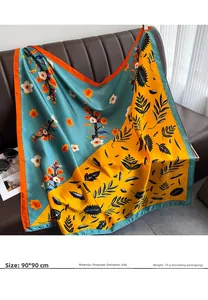Detail of 90x90cm satin square scarf with floral pattern on leather sofa