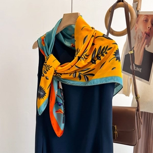 Floral satin square scarf in yellow and blue, styled with a dress and luxury accessories