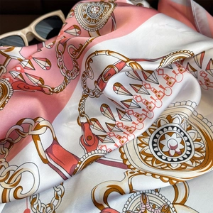 Detailed shot of silk scarf with chain pattern and elegant golden buckle print