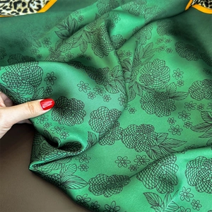 Elegant emerald green satin silk scarf with floral print and leopard print border edge