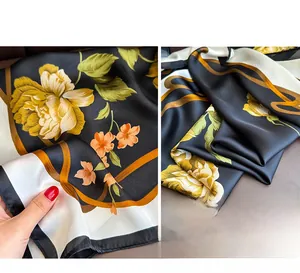 Detailed shot showing the silky texture and vibrant floral print of the large square scarf