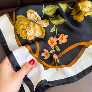 Elegant floral silk scarf with yellow peonies and gold ribbon patterns on black and white