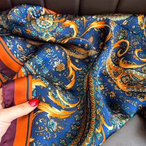 Blue paisley silk-like square scarf with orange floral pattern and satin finish