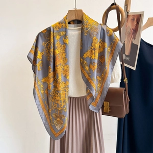 Elegant grey faux silk square scarf with gold baroque print on a stylish outfit