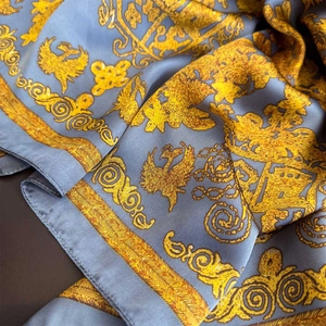 Blue and gold baroque print satin silk scarf with ornate pattern and soft drape texture