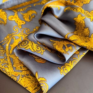 Elegant silk-satin square scarf featuring golden baroque patterns on silver grey fabric