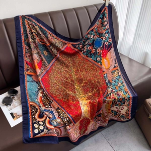 Vintage bohemian silk-like square scarf featuring a tree of life print on a sofa