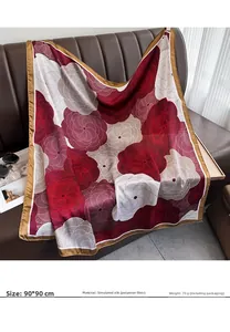 Close-up of 90x90cm floral silk scarf with elegant red spiral patterns and gold satin edges