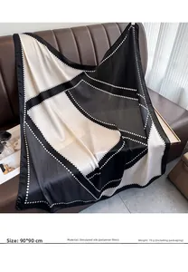 Detail of 90x90cm satin square scarf with geometric print on a leather background