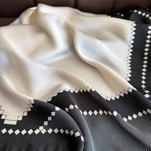 Elegant black and white satin square scarf with geometric patterns and silky texture